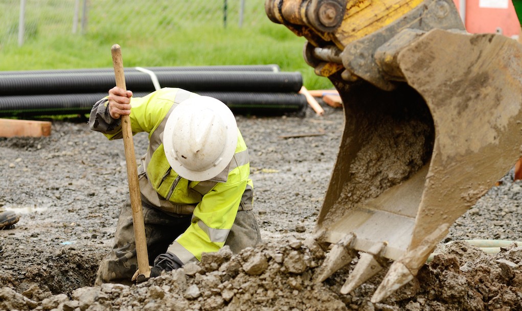 construction worker digging a hole