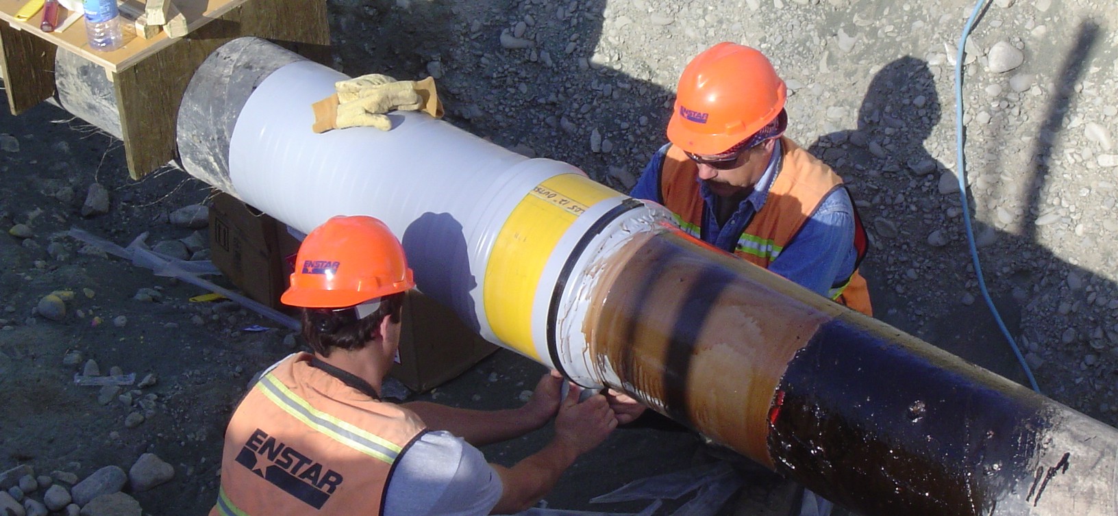 ENSTAR Employees working on pipeline